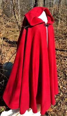 "This long bold red cloak is a full circle of soft warm fleece, giving it wonderful movement and flow. This full length hooded cloak is available at up to 58\" long. It has a full hood and closes with a matching cloth frog. This cloak is a great costume piece for your local renaissance faire or festival and is comfortable for cool days. It is wonderfully cozy, like wearing a nice fleece blanket! To measure the proper length for your cloak, measure from your shoulder to the length down your leg y Red Cape Costume, Fantasy Palace, Long Cloak, Winter Cloak, Red Cloak, Cape With Hood, Cape For Women, Hooded Cloak, Long Red