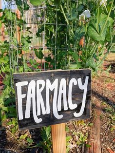 a sign that says farmacy on it in front of a garden with plants