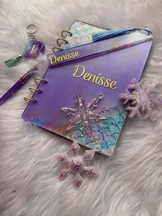 an open planner with snowflakes on it and the words denise daisse