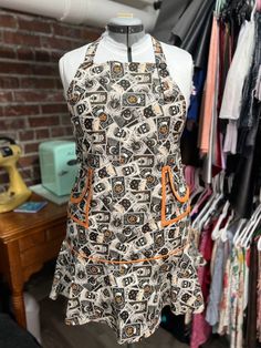 a mannequin with an apron on it in front of clothes