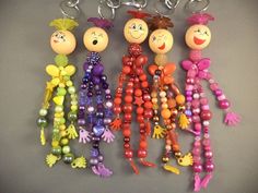 several key chains with different colored beads and cartoon characters on them, hanging from hooks