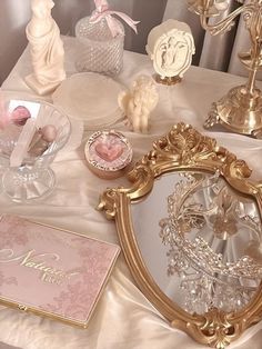 a table topped with pink and gold items