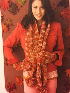 a young woman wearing a red jacket and scarf