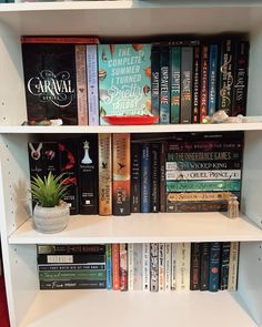 a white book shelf filled with lots of books