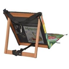 a folding chair with an umbrella and magazine holder on the back, sitting in front of a white background