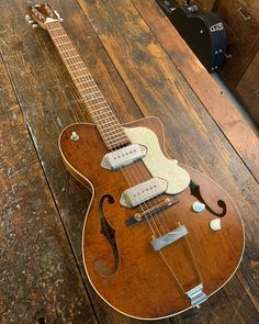 an electric guitar sitting on top of a wooden floor