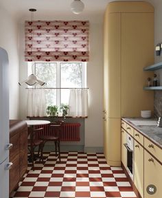 a kitchen with checkered flooring and yellow cabinets