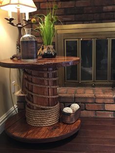 a wooden table sitting on top of a hard wood floor next to a fire place