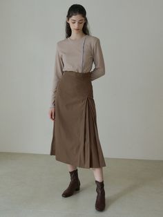 Editor's NotesThis A-line long skirt is designed with inverted pleats at one side that gives a fun asymmetric treat. It has a high-waist for an elongated silhouette. - Back concealed zipper fastening- One-side pleat at the front- High waist- A-line silhouette- Midi-length- LinedMeasurements (in.) S / M - Total Length: 32.3 in. / 32.7 in. - Waist: 12.8 in. / 13.6 in.- Hip: 17.3 in. / 18.3 in. - Hem: 21.7 in. / 22.4 in. * Recommend size S for waist size 24-26, size M for waist size 27-28.Model Info: 5' 6.5 / Fitting size SComposition & Care- 98% Polyester, 2% Polyurethane- Dry cleanDesigner- by REORG Beige Asymmetrical Pleated Skirt, Asymmetrical Pleated Skirt In Beige, Beige Asymmetrical Pleated Maxi Skirt, Beige Pleated Asymmetrical Maxi Skirt, Brown Long Pleated Skirt For Work, Beige Long Skirt With Accordion Pleats, Pleated Flared Wrap Skirt For Fall, Ribbed Knit Top, Pleated Midi Skirt