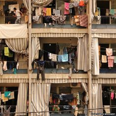 an apartment building with several balconies and clothes hanging out to dry on the balcony