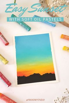 easy sunset with soft oil pastels and crayons on the table next to them