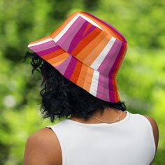 Are you ready to rock a reversible lesbian flag bucket hat for pride month and beyond? This awesome accessory is perfect for showing off your lesbian pride and visibility, whether you're heading to a summer festival or marching in the pride parade.The hat features two distinct sides. On one side, you'll find the beautiful ombré shades of the lesbian sunset flag. This design features a gradient of orange, white and pink shades. The other side of the hat is boldly emblazoned in the stunning 7 colo Colorful Adjustable Bucket Hat, Sunset Flag, Lesbian Flag, Pink Shades, Pride Parade, The Pride, Rock A, Gifts For Your Girlfriend, Pride Month