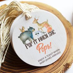 a round tag with an image of two animals and the words pop it when she pops