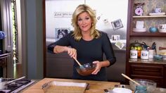 a woman is mixing something in a bowl