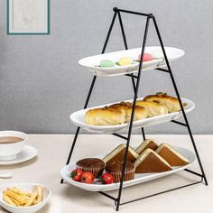 three tiered trays with different types of pastries and desserts on them