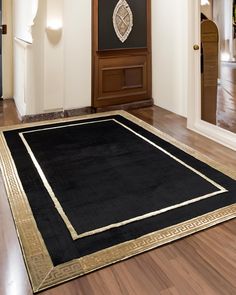 a large black rug with gold trim on the floor