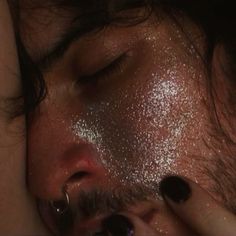 a close up of a person with glitter on their face