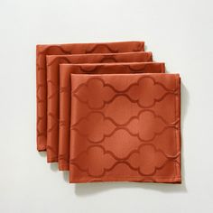 three orange napkins on top of each other