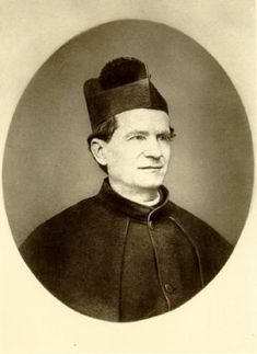 an old black and white photo of a man in a priest's outfit with a hat on his head