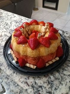 a cake that has strawberries on top of it