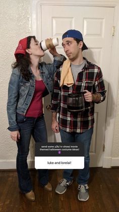 two people standing next to each other in front of a door with a sign on it