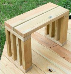 a wooden bench sitting on top of a wooden deck