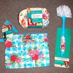 the contents of a flowery purse are laid out on the floor next to it