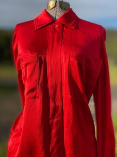 Gorgeous Red Silk Blouse Designed by Margaretha Ley for Escada in the 1980s. 100% pure silk. It has a double collar, angular breast pockets, hidden front button panel and shell buttons. Made in Italy. Marked size 36. Please refer to measurements below for most accurate sizing as vintage sizing differs. Rare and beautiful! In excellent condition. Measurements: Length: 28" Sleeve Length: 26" Cuff: 2.5" Shoulder Width: 16" Armpit to armpit: 20" *Every effort is made to accurately describe the condition of our items and their measurements. We want you to be happy with your purchase. All items are vintage and may show some signs of aging. They are not brand new. All items are sold as is. Please be sure the measurements listed are a good fit for you. Red Silk Blouse For Work, Red Silk Blouse, Blouse Designed, Double Collar, Blouse Designs Silk, Shell Buttons, Button Up Blouse, Red Silk, Silk Blouse