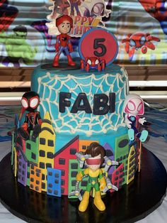 a birthday cake is decorated with cartoon characters and the number five on it's side