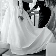 the bride is getting ready to walk down the aisle in her wedding dress, which features long sleeves