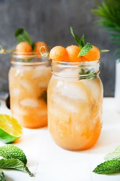 two mason jars filled with lemonade and mint garnish