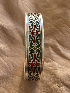 "This is a great silver and enamel cuff bracelet from Morocco. It measures just under 5/8\" (1,45 cm) at the widest and the inner diameter is just over 2 3/8\" (6,1 mm) wide. It is slightly adjustable as it is a cuff style bracelet. The bracelet features fantastic filigree-style wirework with unique-colored enamel." Ornate Oxidized Cuff Bracelet Bangle, Bohemian Antique Silver Adjustable Cuff Bracelet, Bohemian Silver Cuff Bracelet With Inlay, Bohemian Enamel Bangle Bracelet, Moroccan Bracelet, Bohemian Turquoise Nickel-free Cuff Bracelet, Protection Amulet, African Jewelry, Big Earrings