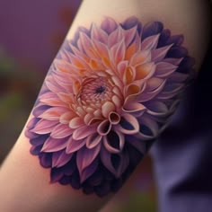 a woman's arm with a pink and purple flower tattoo on the left forearm