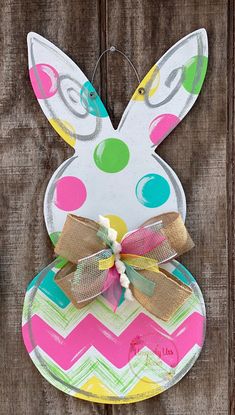 a paper plate with an easter bunny on it and a bow hanging from the side