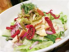 a white bowl filled with salad and vegetables