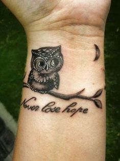 an owl tattoo on the wrist saying you've got hope