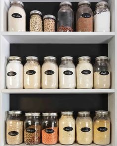 the shelves are filled with different types of spices and grains in glass jars on them