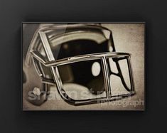 a black and white photo of a football helmet