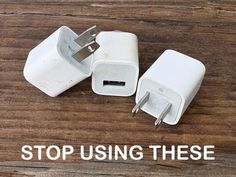 two white plugs sitting next to each other on top of a wooden floor with the words stop using these