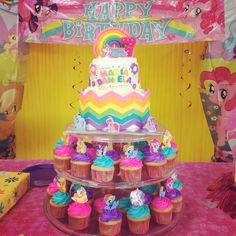 a birthday cake and cupcakes on a table