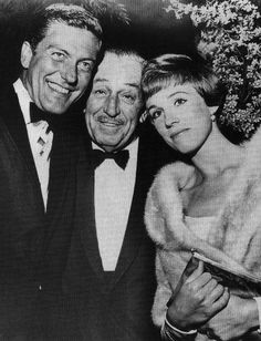 an old black and white photo of two men and a woman posing for the camera