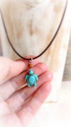 "Blue turquoise magnesite stone turtle hangs on mahogany wood bead and  brown leather cord , that finished with silver or gold metal findings . Beautiful pendant for any summer activity ! If you are looking for white turtle necklace - it's her : https://www.etsy.com/listing/467315027/sea-turtle-howlite-choker-turquoise?ref=shop_home_active_3 Size : 18 \" cord           1 \" 1/4 '  pendant with loop   If you'll need a different size - please convo me." Spiritual Turquoise Jewelry With Adjustable Cord, Brown Pendant Jewelry With Adjustable Cord, Handmade Adjustable Turquoise Necklace As Gift, Spiritual Adjustable Turquoise Necklace Gift, Handmade Turquoise Jewelry With Waxed Cord, Adjustable Turquoise Amulet Necklace, Natural Stone Pendant On Waxed Cord, Turquoise Waxed Cord Jewelry Gift, Natural Stone Pendant With Waxed Cord