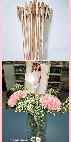 a vase filled with pink flowers and wooden sticks sticking out of it's sides