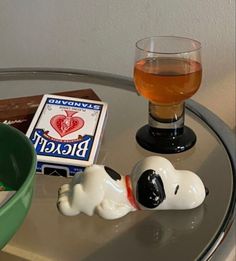 there is a glass of beer and a toy dog on the table