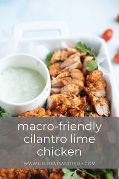 a white tray filled with chicken next to a small bowl of ranch dressing on the side