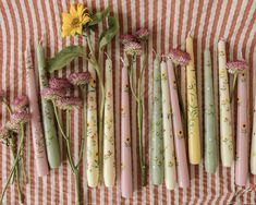 Table is laid with a pile of dinner candles that have been hand painted with various flower designs. Garden Trinkets, Pretty Candles, Vegetable Harvest, Daisy Chains, Dinner Candle, Pretty Candle, Hand Painted Candles