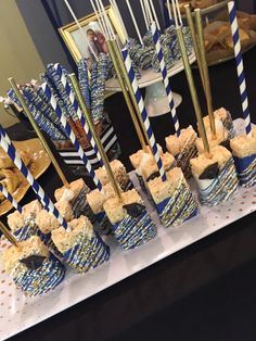 blue and white desserts on a table with gold striped straws in the middle