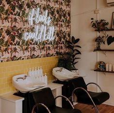 a couple of chairs that are sitting in front of a wall with some writing on it