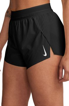 These mid-rise running shorts offer moisture-wicking comfort and side slits to keep you moving with comfort and confidence. 3" inseam; 23" leg opening; 12 1/2" front rise; 15" back rise (size Medium) Elastic waist with internal drawcord Three internal drop-in pockets Dri-FIT moisture-wicking technology Stretch lining 86% polyester, 14% spandex Machine wash, tumble dry Imported Nike Air Swift Shorts, Cute Sweat Shorts, Running Attire Women, Things To Buy For Summer, Running Essentials For Women, Girly Workout Outfits, Cross Country Outfits, Spandex Shorts Outfit, Tracksmith Running