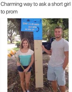 a man and woman standing next to a tall blue sign that says short girl problems